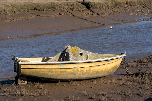 Old stranded boat in Norfolk, low tide