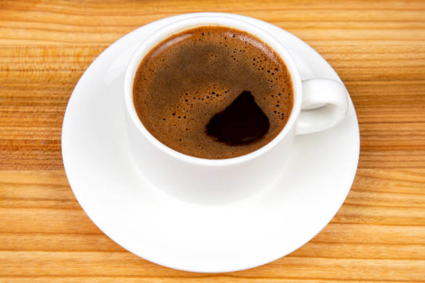 istock white cup of hot black coffee on a cork table 1386413018