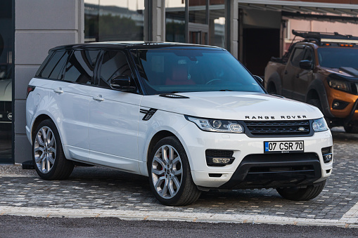 Side; Turkey – March 05 2022:     white Land Rover Range Rover Sport  is parked  on the street on a warm day