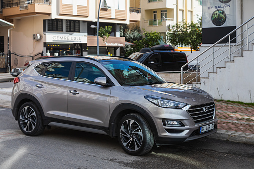 Side, Turkey -February  20, 2022: silver Hyundai Tucson  is parked  on the street on a warm day against the backdrop of a shops
