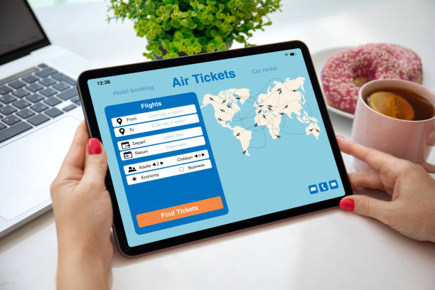 istock female hands holding computer tablet with application searching air tickets 1386418083
