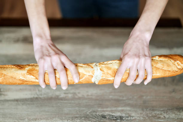 istock Female hands holding a loaf of bread 1386418347