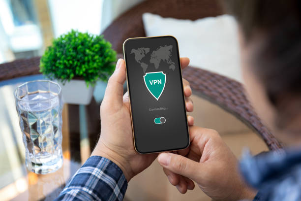 istock male hand holding phone with app vpn on the screen 1386419540