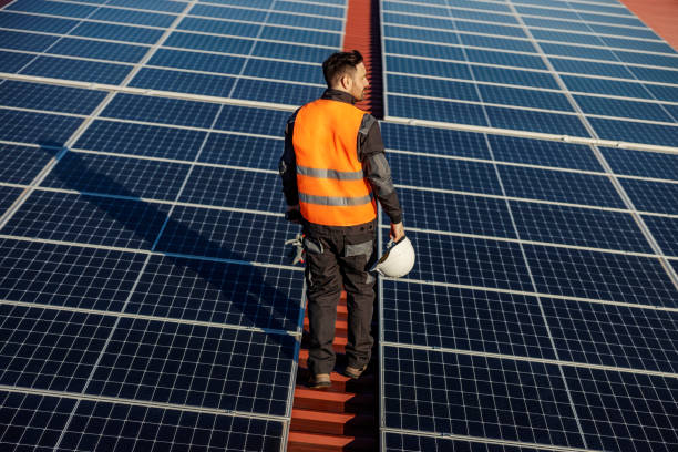 istock Rear view of a worker looking for solar panels to maintain. 1386419827