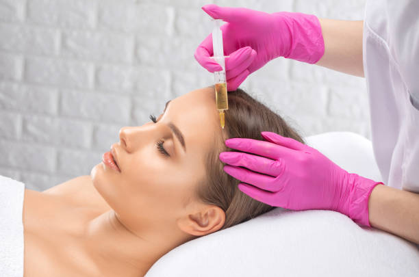 Cosmetologist makes rejuvenating anti wrinkle injections on the face of a beautiful woman. Female aesthetic cosmetology in a beauty salon. Cosmetologist makes rejuvenating anti wrinkle injections on the face of a beautiful woman. Female aesthetic cosmetology in a beauty salon. human centrifuge stock pictures, royalty-free photos & images