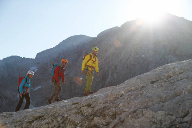 istock Group of mountaineers walking on the edge 1386421948