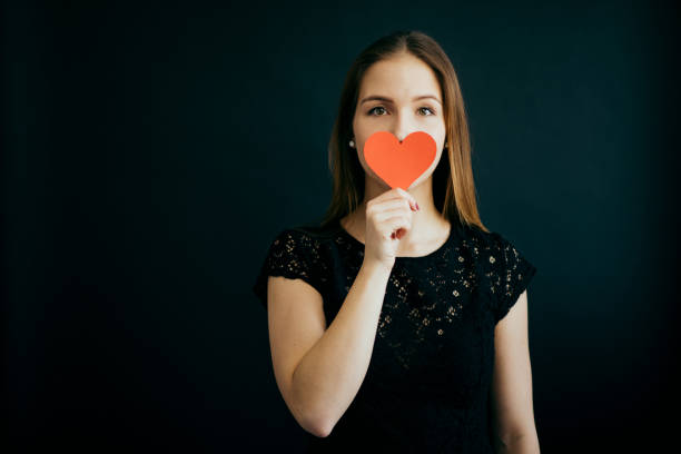 istock Beautiful girl holding artificial heart 1386428164