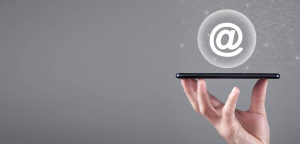 istock Male hand showing smartphone with a email symbol. 1386436431