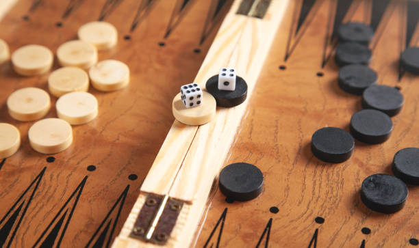 istock Figures with dice. Wooden backgammon board game 1386436443
