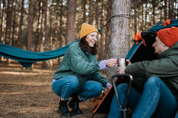 istock Young adult couple camping in forest 1386436679