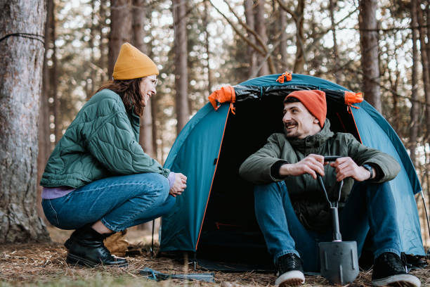 istock Young adult couple camping in forest 1386436706
