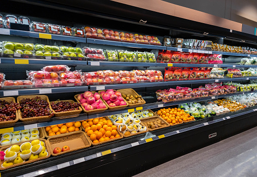 Various of fresh fruits on shelf in modern supermarket.