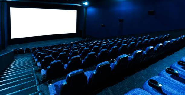 Empty movie theatre interior with screen and seats