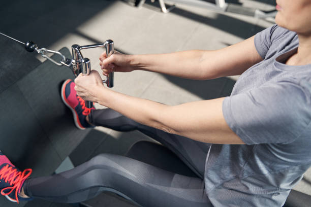 istock Sporty woman doing exercise with gym equipment 1386453676