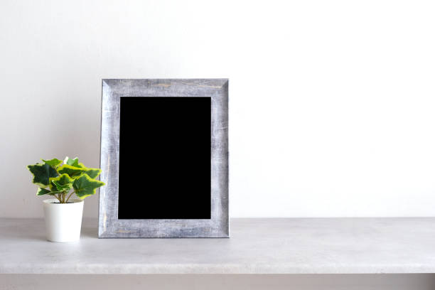 istock Blank grey vintage wooden frame on table and white wall background , banner, with copy space for mock up, template 1386458220