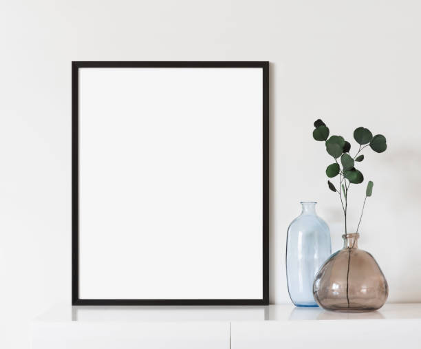 istock Artwork mock-up in interior design. Blank picture frame on a cupboard, portrait orientation 1386464411