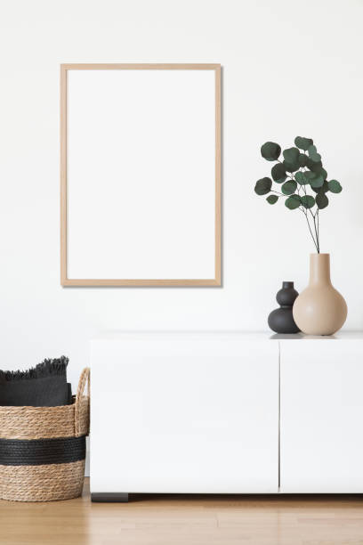 istock Artwork mock-up in interior design. Blank vertical picture frame on a cupboard 1386465845