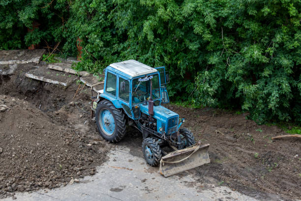 istock Tractor, bulldozer with mounted implement works on earthworks 1386468852