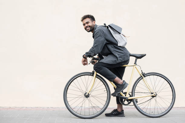 istock Handsome young man with bicycle in a city 1386474612