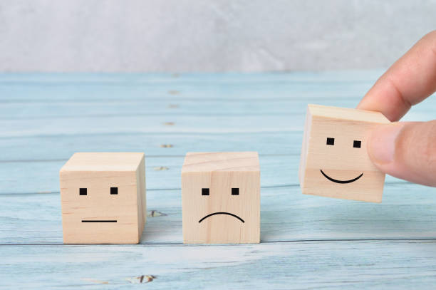 istock Customer service evaluation and satisfaction survey concepts. The client hand picked the happy face smile icon 1386474644