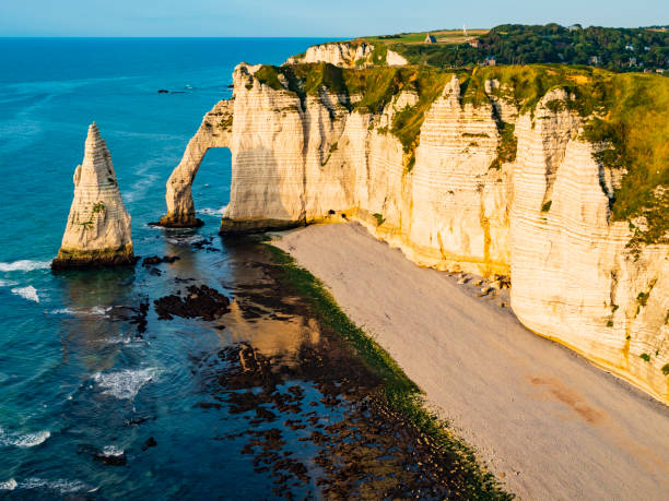 istock Panoramic view of Etretat coastline, vertical chalk cliffs with impressive arch and pinnacle, Normandy, France 1386477208