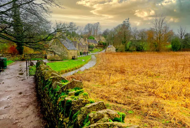 A landscape scene across the fields to Arlington Row in Bibury