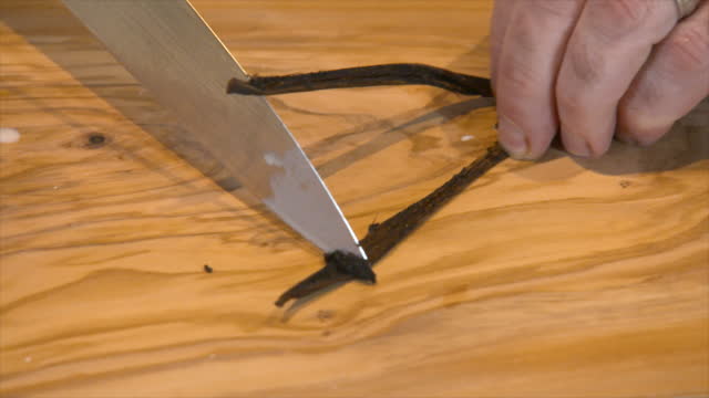 Chef slicing fresh vanilla bean