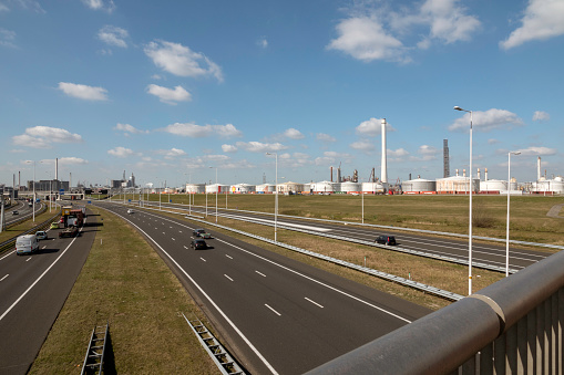 Pernis,Holland,18-march-2022:shell refinery pernis near rotterdam in the dutch industrial area europoort with high chimney and the storage tanks visible