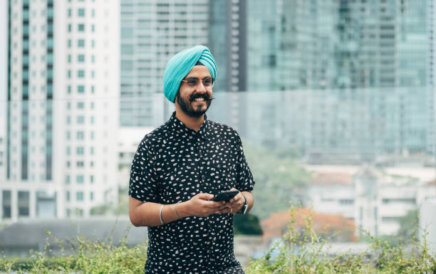 istock Happy Indian Businessman Using Mobile Phone Outdoors 1386482690