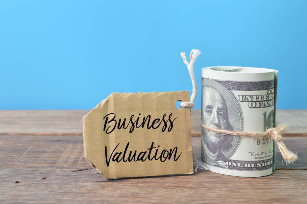 istock Money banknotes and label tag written with text BUSINESS VALUATION 1386484010