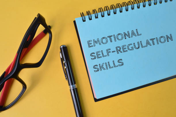 istock Pen, eyeglasses and notebook written with text EMOTIONAL SELF-REGULATIONS SKILLS 1386484064