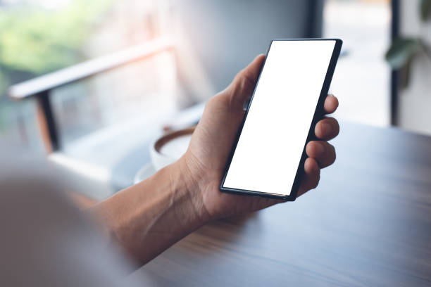 istock Mockup of man using smartphone in cafe 1386486456