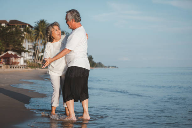 istock The romantic Asian senior couple dancing while standing on summer beach sunset. Travel leisure and activity after retirement on vacations and summer concept. Vacation and relaxation time. 1386486607