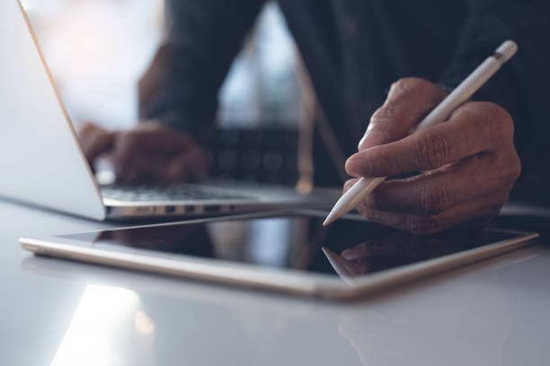 istock Business man working on laptop in modern office 1386486715