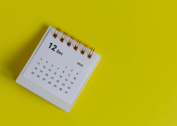 istock Tear-off calendar for December 2022 on a yellow background. 1386486739