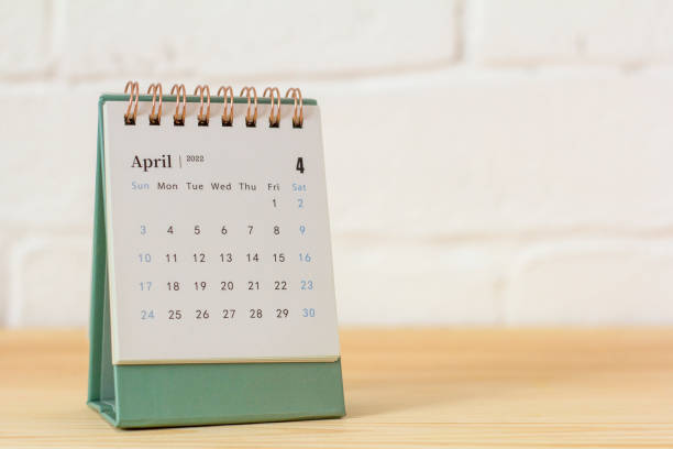 istock Desktop calendar for April 2022 for planning on the table. 1386487499