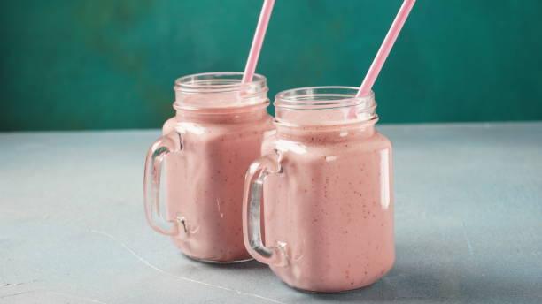istock Strawberry milkshake in mason jars with fresh strawberries 1386487874