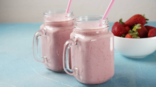 istock Strawberry milkshake in mason jars with fresh strawberries 1386487875