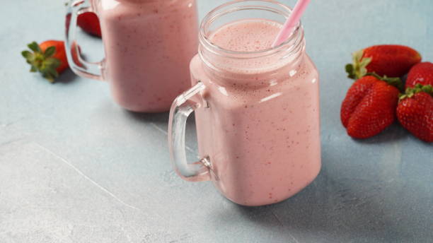 istock Strawberry milkshake in mason jars with fresh strawberries 1386487876