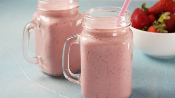 istock Strawberry milkshake in mason jars with fresh strawberries 1386487884