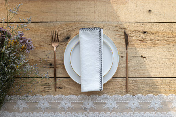 istock empty plate with cutlery and napkin on wooden background 1386491233