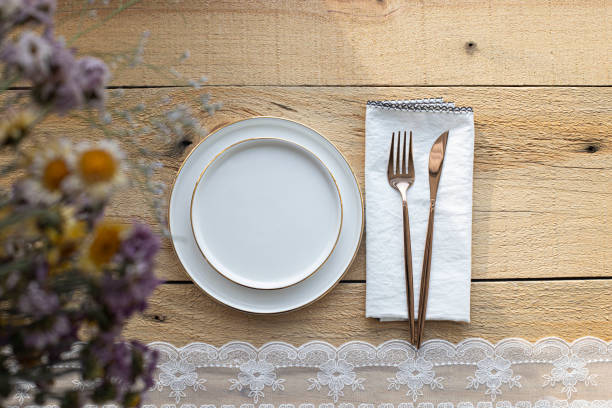istock empty plate with cutlery and napkin on wooden background 1386491236