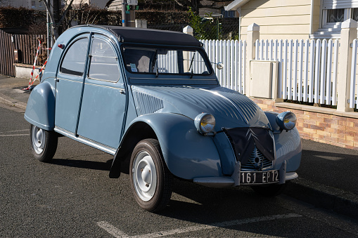 Le Mans, France - February 27, 2022: An old blue old timer classic Citroen 2CV (Dodoche) car in a very good shape. Parked in Le Mans street. French lifestyle. Sunny winter day. Selective focus