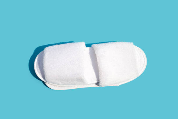 istock Hotel slippers on blue background. Copy space 1386493805