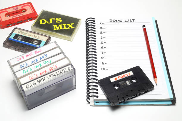 Retro audio cassette tape from the 80s and 90s on a white background. blank playlist on notebook. Top view, nostalgic concept. Retro audio cassette tape from the 80s and 90s on a white background. blank playlist on notebook. Top view, nostalgic concept. reel to reel tape stock pictures, royalty-free photos & images