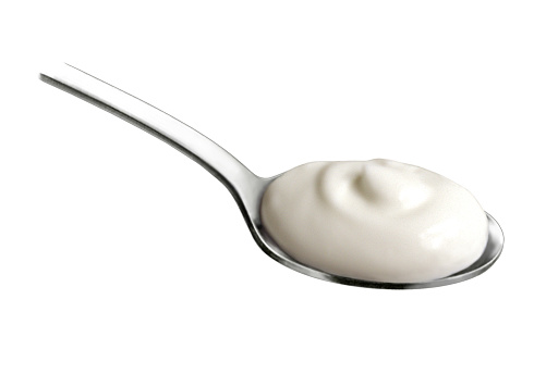 An illustration of a stainless steel spoon with a dollop of sour cream.