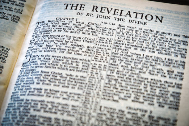 Close up of Holy Bible page, shallow depth of field with focus on book chapter, heading. Close up of Holy Bible page, shallow depth of field with focus on book chapter, heading. Revelation new testament stock pictures, royalty-free photos & images
