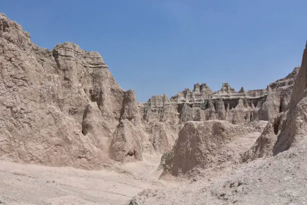 Several towering pinnacle rocks carved out of the arid dry landscape.