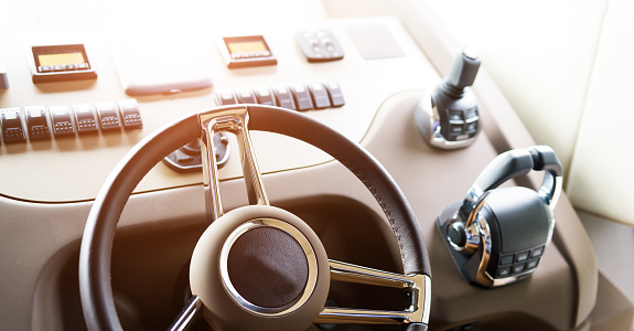 Steering wheel on luxury yacht cabin.