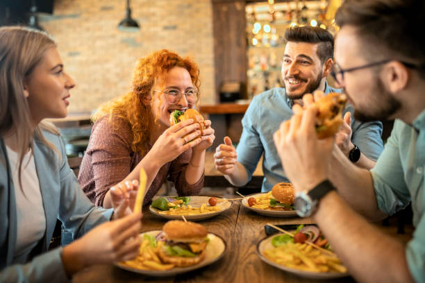 istock Friends eating together 1386498351